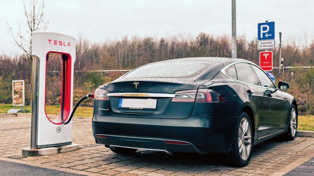 A Tesla Model S charging at a station